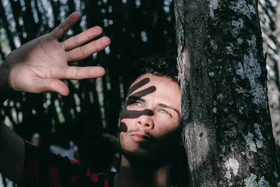 Person holding up their hand to block the sun