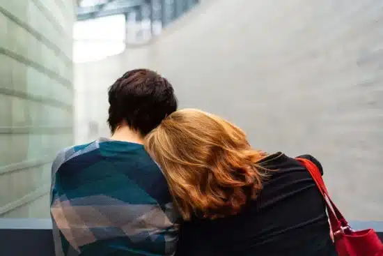 Woman laying her head on a shoulder