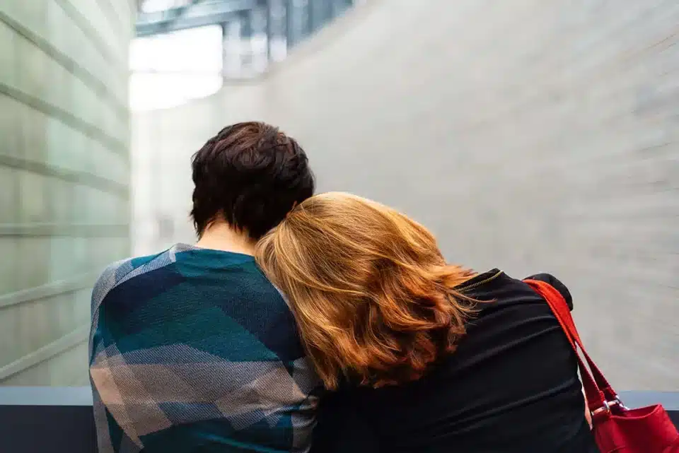 Woman laying her head on a shoulder