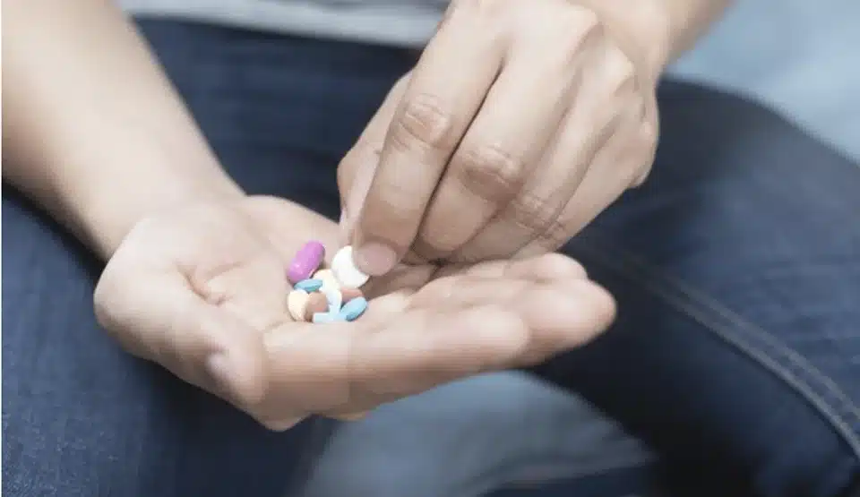 Hands holding pills