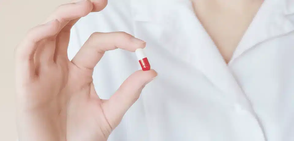 Person holding a pill