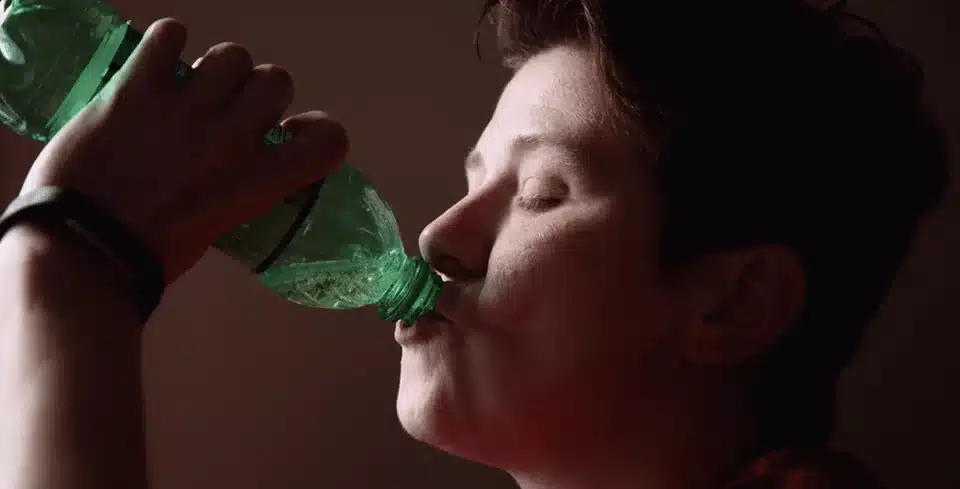 Person drinking from a bottle