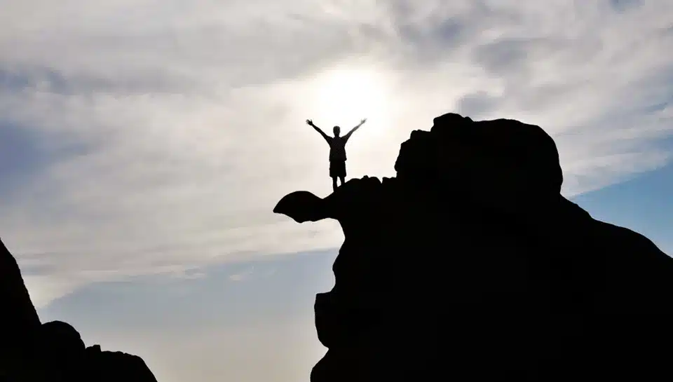 Person on a cliff silhouette