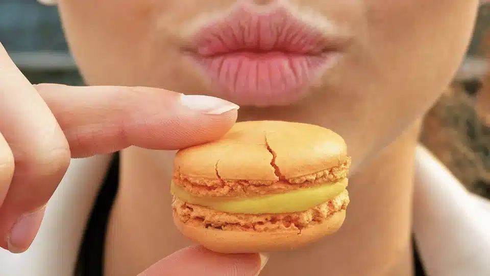 Woman holding macaroon