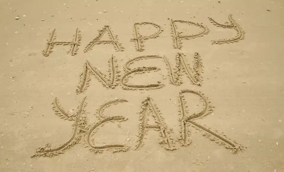 Happy New Year written in the sand