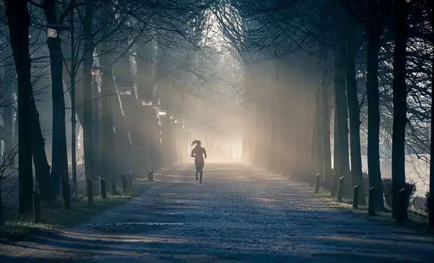 Woman running through forest