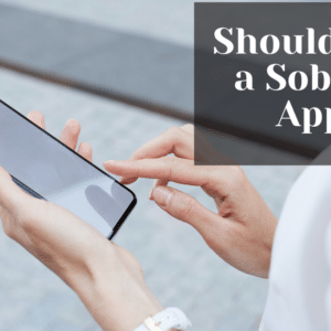 A photo of a woman's hand holding a smartphone with the text "Should I Use a Sobriety App?" written on the screen.