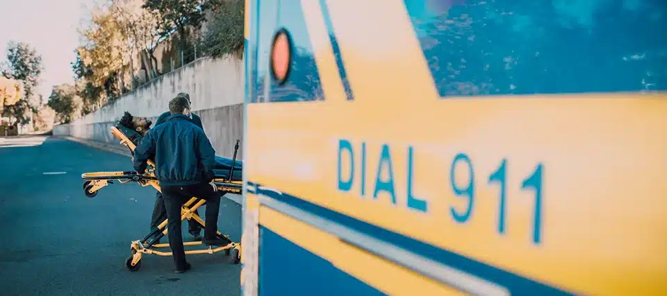 Person being loaded into an ambulance