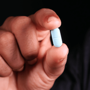 M365 Pill Medication Management Norco Watson A close-up image of a pill being held in someone's fingers.