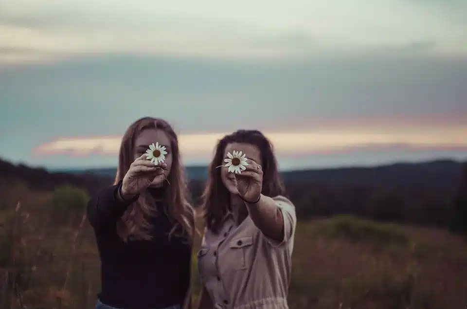 Two girls holding flowers