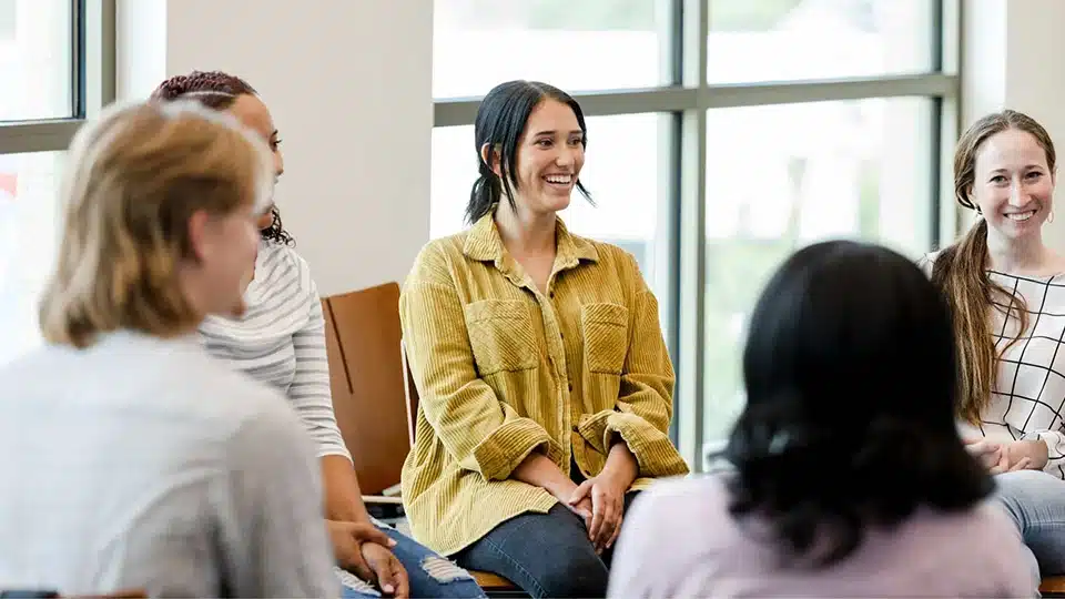 Person in group smiling at the group