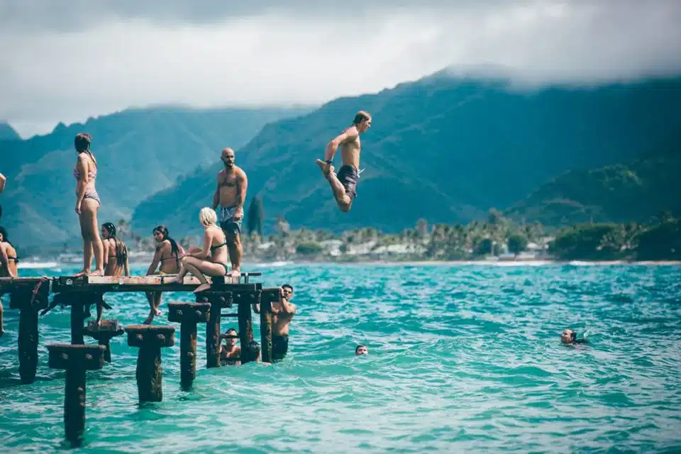 People jumping into a lake