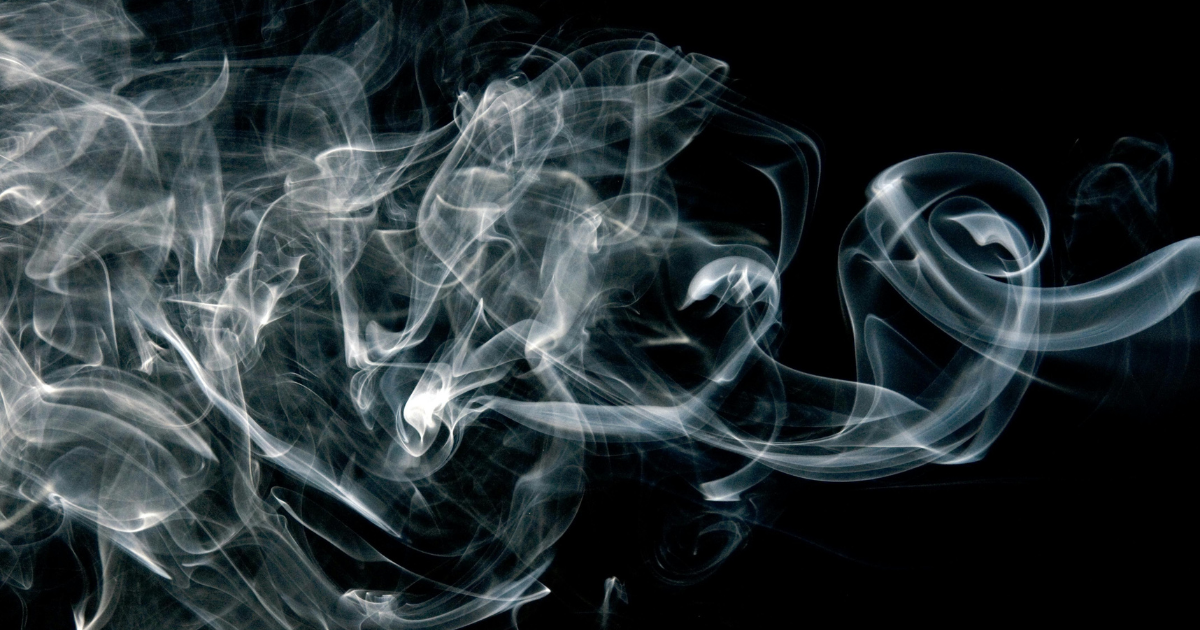 Smoke on black background, related to Adderall risks and effects, potential dangers of smoking medication.