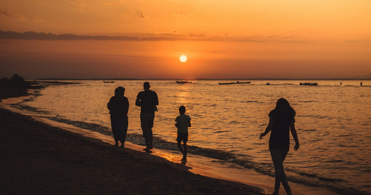 Sunset beach walk: Silhouettes of family members enjoying the scenic view. Vyvanse withdrawal timeline inspiration.
