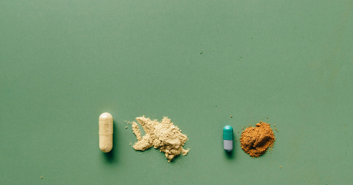 Crack vs Meth: Comparison of pills and powder forms of crack cocaine and methamphetamine on a green background. Drug differences.