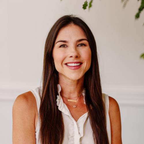 Our Team: Portrait of Amanda Greiwe, smiling professional woman with long brown hair. Team member headshot.