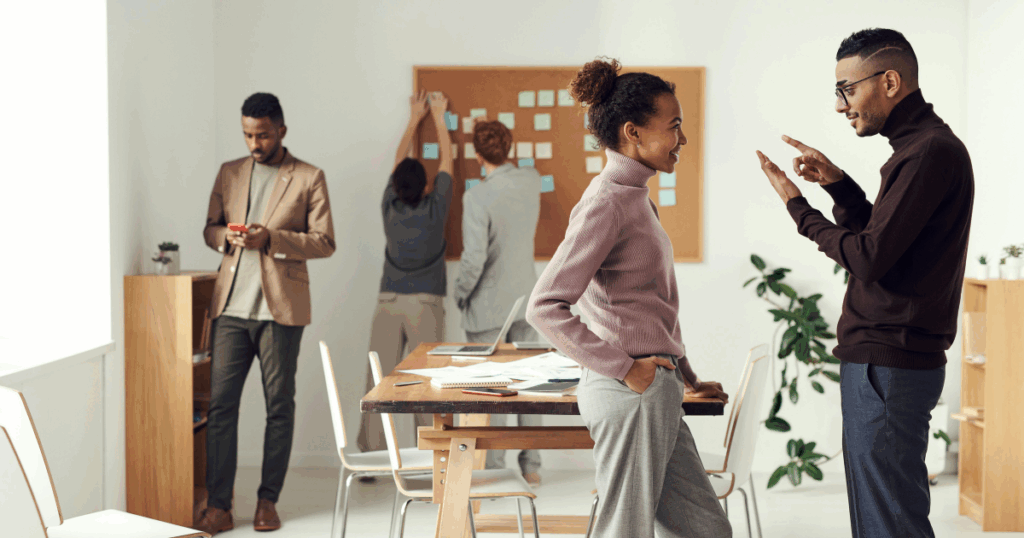 Team collaboration in modern office. Diverse group brainstorming ideas on a corkboard, showcasing teamwork and communication.