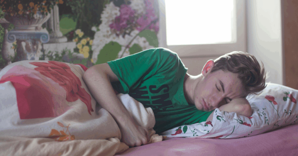 Wellbutrin withdrawal symptoms: A young man sleeping, illustrating potential fatigue and sleep disturbances during withdrawal.