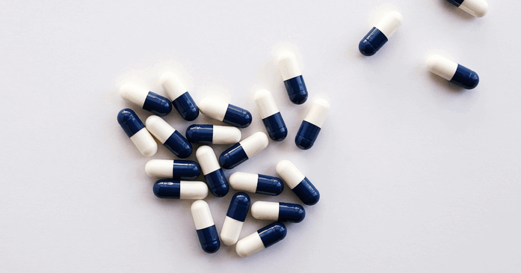 Xanax anxiety medication pills. Blue and white capsules for anxiety management. Xanax medication close-up.