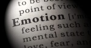 Close-up of a printed page with the word 'Emotion' in focus, suggesting psychology or feelings.