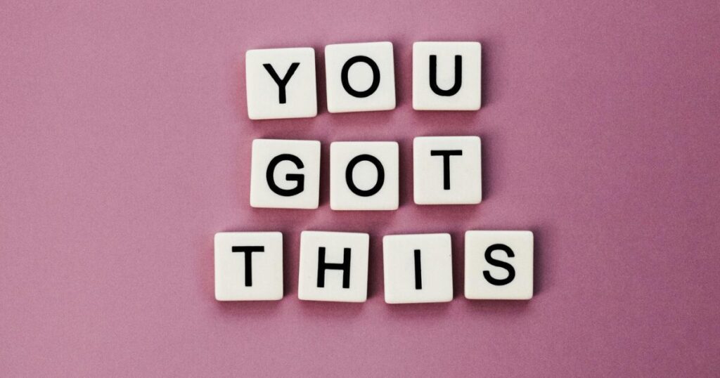 Motivational graphic with white letter blocks spelling 'YOU GOT THIS' on a pink background.