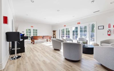 Bright lounge with pool table, seating area, bar stool, and natural light in Santa Ana. Luxury interior design.