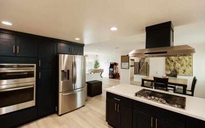 LP Facility Kitchen Tour: Modern black cabinets, stainless steel appliances, open floor plan with game room.