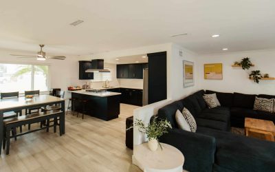 LP Facility Tour: Modern home interior featuring a dark kitchen, dining area, and comfortable living space.