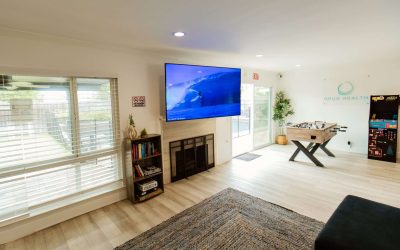 Opus Health Facility Tour: Recreation room featuring a large TV, foosball table, and arcade game. Modern and relaxing.