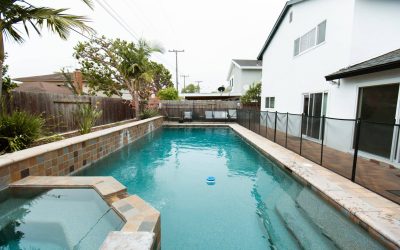 Luxury backyard pool and spa with safety fence at LP facility. View our outdoor facilities, perfect for relaxation and recreation.