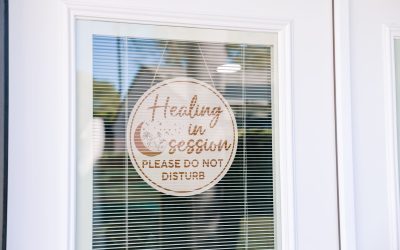 Healing session in progress sign on a door with blinds, please do not disturb. Wellness practice, therapy room.