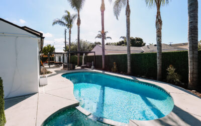 Backyard oasis: Swimming pool, palm trees, outdoor seating. A luxury outdoor living space for relaxation and recreation.