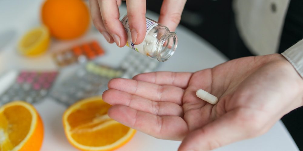 close up of pouring a pill into hands